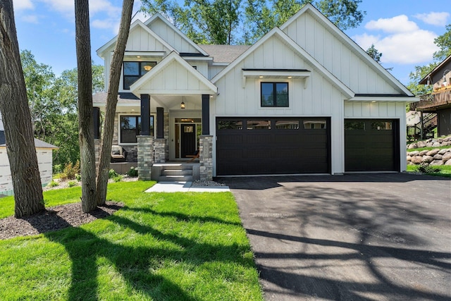932 Orchard Ln, Roseville, MN 55113 - view of front of house with board and batten siding, driveway, a front lawn, and a shingled roof