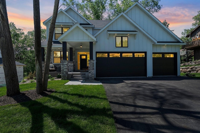 932 Orchard Ln, Roseville, MN 55113 - view of front of house featuring board and batten siding, asphalt driveway, a yard, and roof with shingles