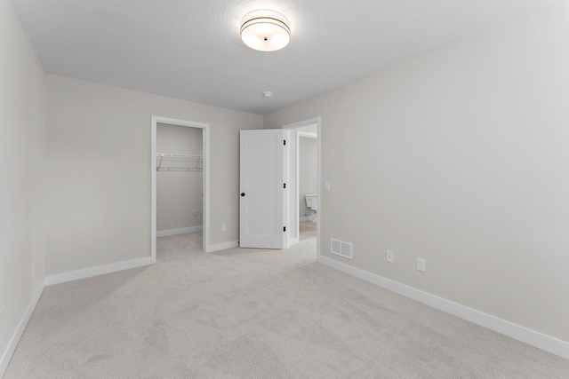 932 Orchard Ln, Roseville, MN 55113 - unfurnished bedroom featuring light carpet, a spacious closet, and a closet