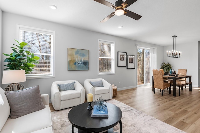 932 Orchard Ln, Roseville, MN 55113 - living area featuring light wood finished floors, ceiling fan, and a chandelier