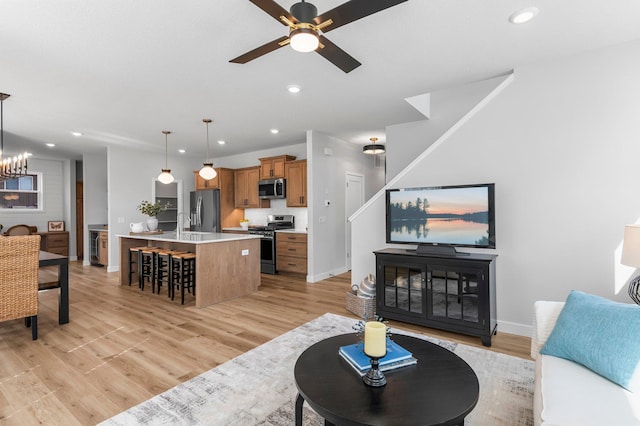 932 Orchard Ln, Roseville, MN 55113 - living area with light wood-type flooring, recessed lighting, a ceiling fan, and a chandelier