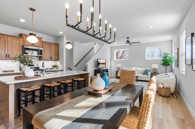 932 Orchard Ln, Roseville, MN 55113 - dining space with ceiling fan, light wood-style floors, stairway, and recessed lighting