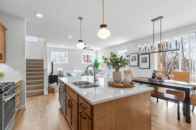 932 Orchard Ln, Roseville, MN 55113 - kitchen featuring stainless steel appliances, healthy amount of natural light, light wood finished floors, a center island with sink, and recessed lighting