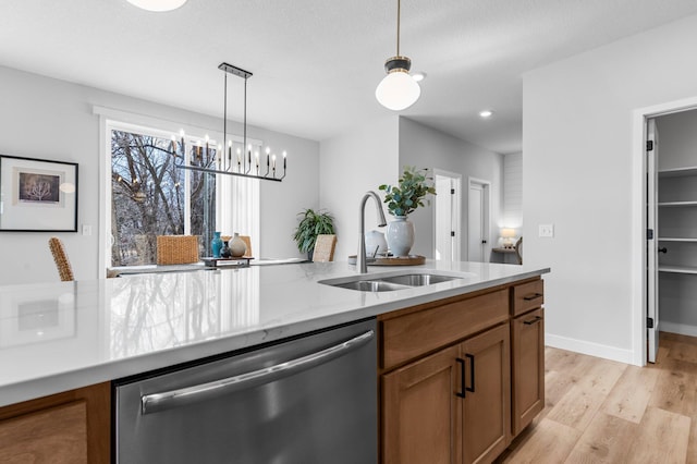 932 Orchard Ln, Roseville, MN 55113 - kitchen with dishwasher, brown cabinetry, light wood-style floors, and hanging light fixtures