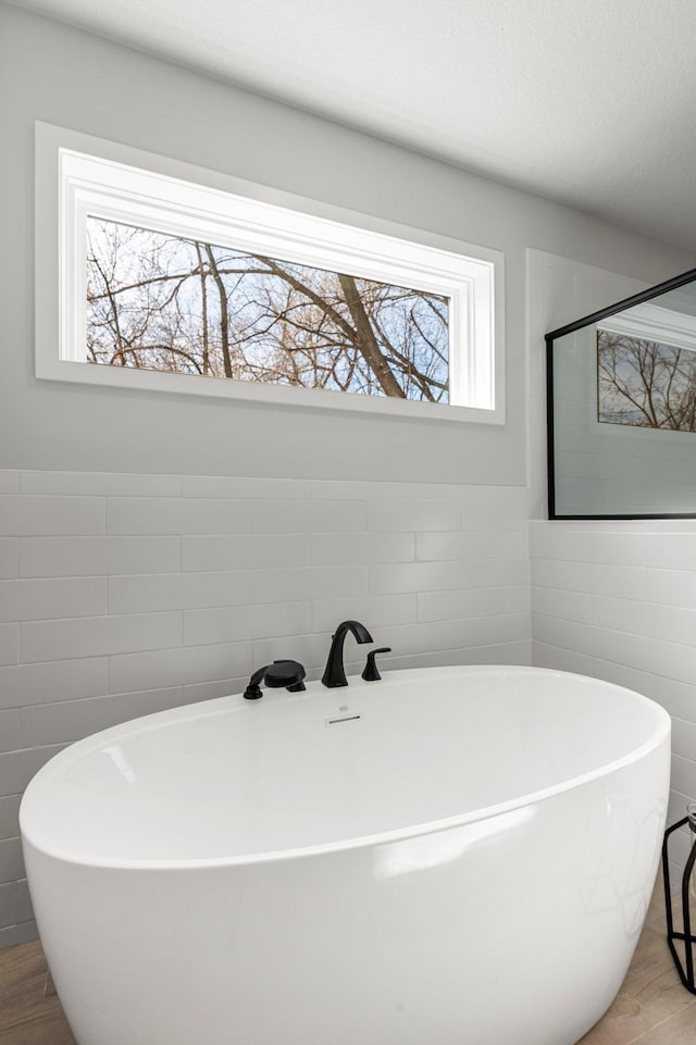 932 Orchard Ln, Roseville, MN 55113 - bathroom with a freestanding bath and tile walls