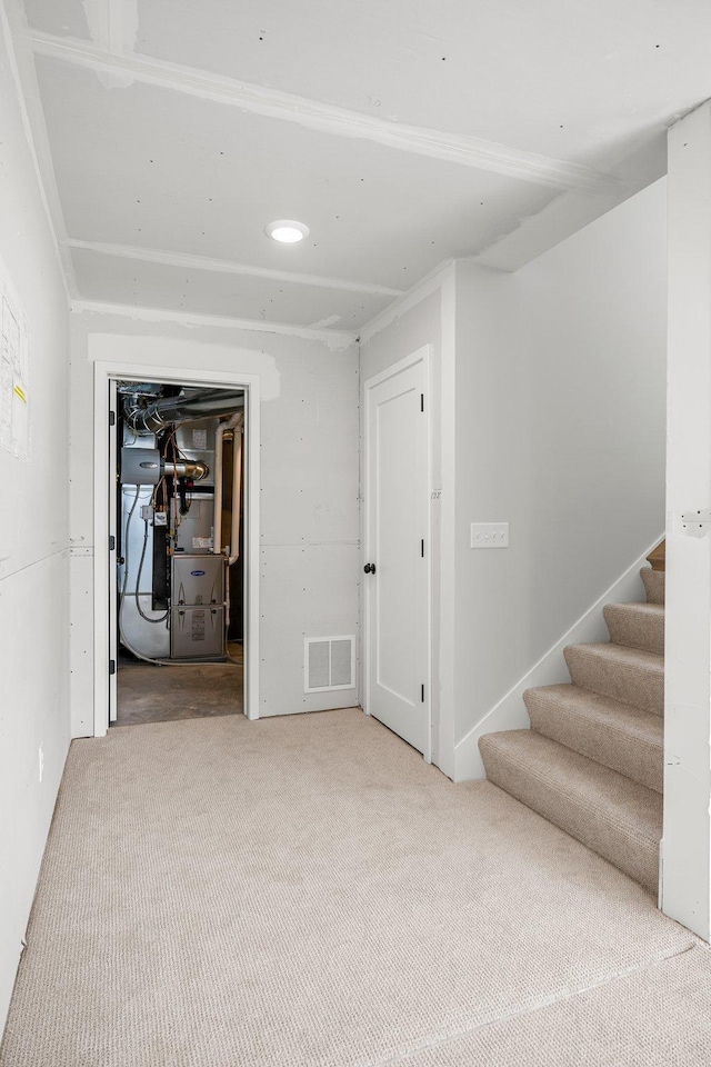 932 Orchard Ln, Roseville, MN 55113 - basement with carpet, stairs, and heating unit