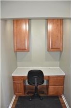 home office with built in study area and baseboards