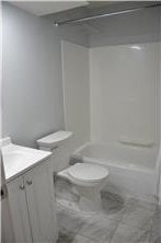 bathroom with shower / tub combination, vanity, and toilet