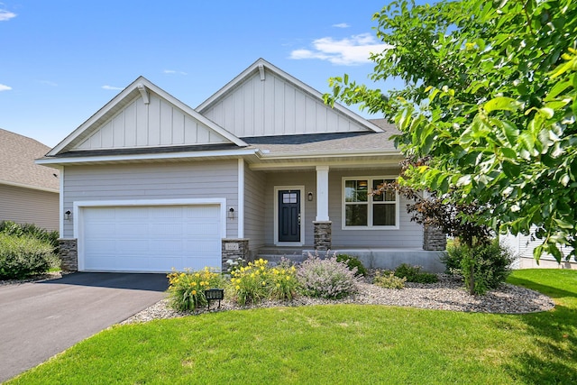 craftsman inspired home with a garage, covered porch, and a front yard