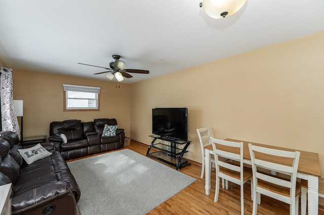 living room featuring wood-type flooring and ceiling fan