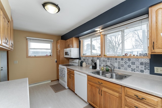 kitchen with white appliances, a baseboard radiator, sink, and decorative backsplash