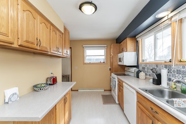 kitchen featuring sink, white appliances, backsplash, a baseboard radiator, and light wood-type flooring