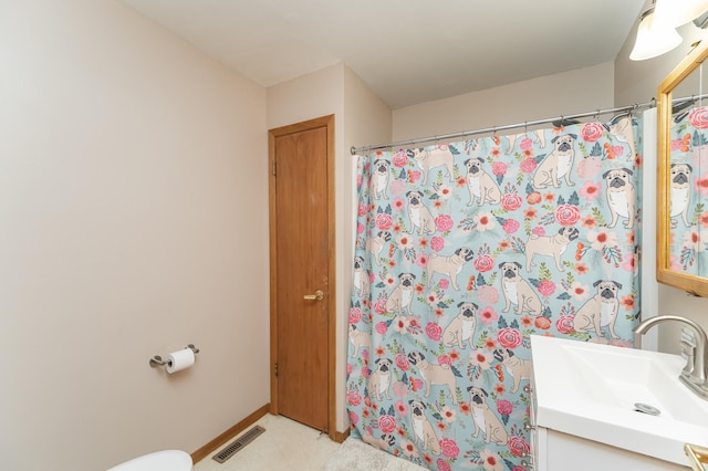 bathroom featuring vanity, toilet, and a shower with shower curtain