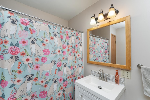 bathroom featuring vanity, backsplash, and a shower with curtain