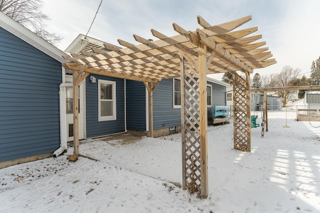 snow covered patio with a pergola