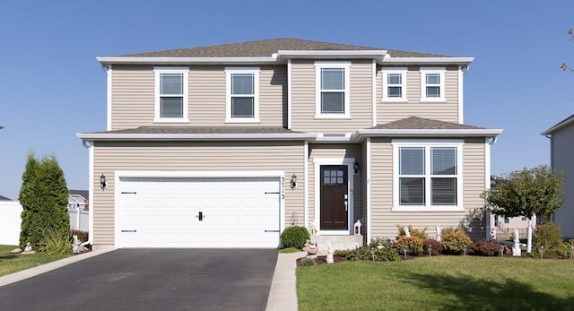 view of front facade with a front lawn and a garage