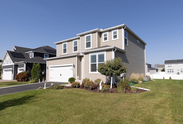 view of front of house with a front yard and a garage