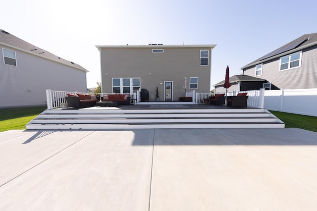 back of house featuring an outdoor living space and a patio area