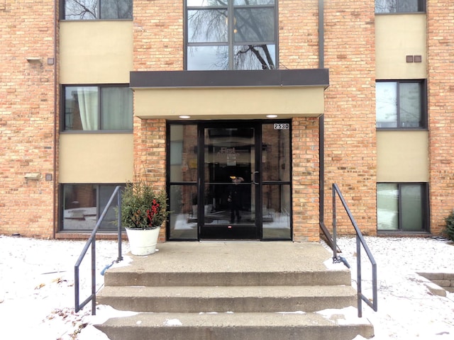 view of snow covered property entrance