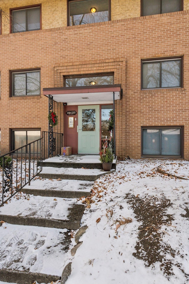 view of snow covered property entrance