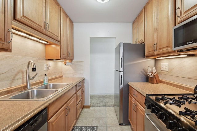 kitchen with appliances with stainless steel finishes, sink, and backsplash