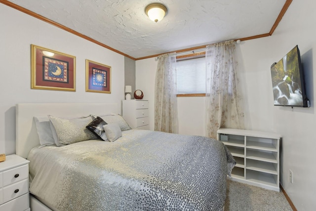 bedroom featuring ornamental molding, carpet flooring, and a textured ceiling