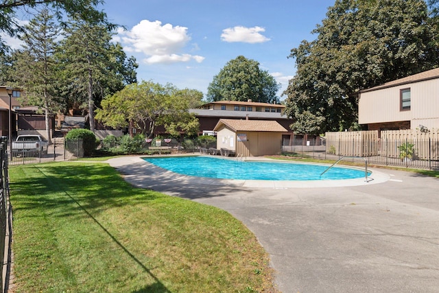 view of pool featuring a yard and a patio