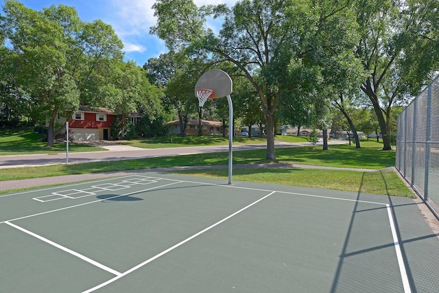 view of basketball court featuring a yard