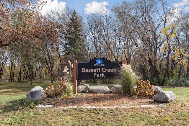 community / neighborhood sign with a yard