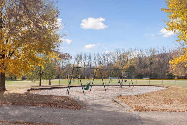 view of playground with a lawn