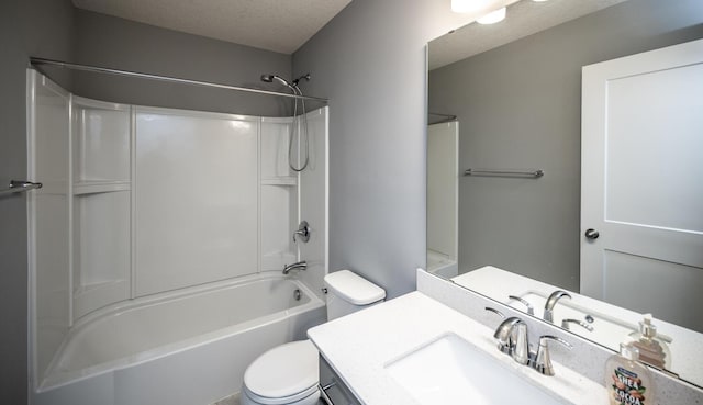 bathroom featuring toilet, bathtub / shower combination, vanity, and a textured ceiling