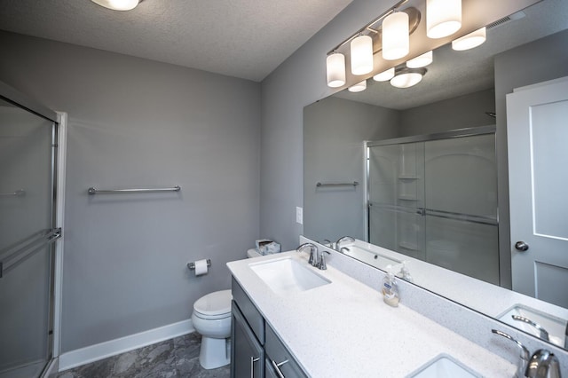 full bathroom featuring a sink, baseboards, toilet, and a shower stall