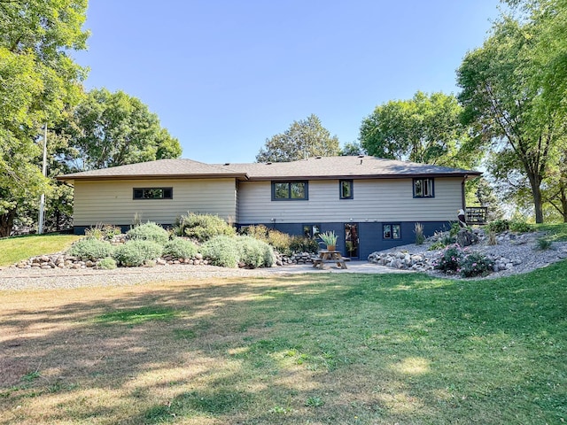 rear view of house featuring a yard and a patio area