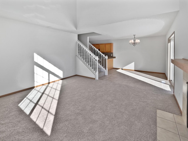 stairs featuring an inviting chandelier and carpet floors