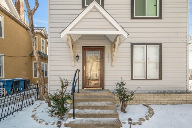 view of snow covered property entrance