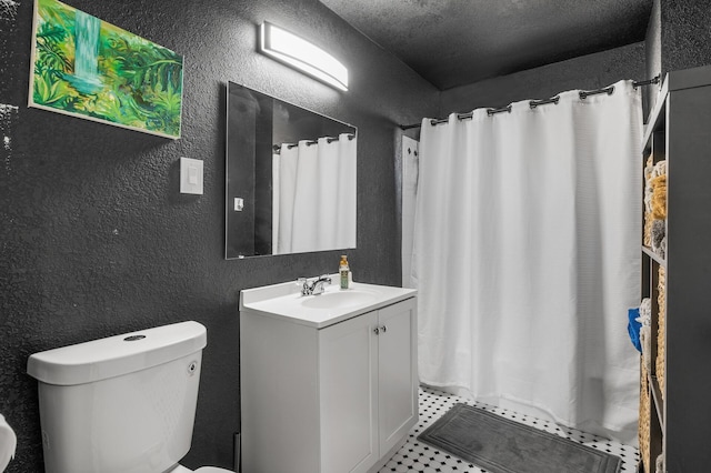 bathroom with walk in shower, vanity, toilet, and a textured ceiling