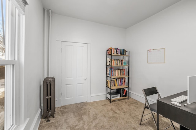 carpeted home office with radiator