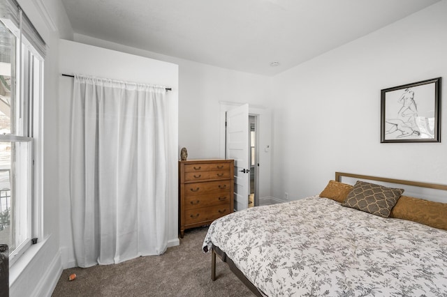 carpeted bedroom featuring multiple windows