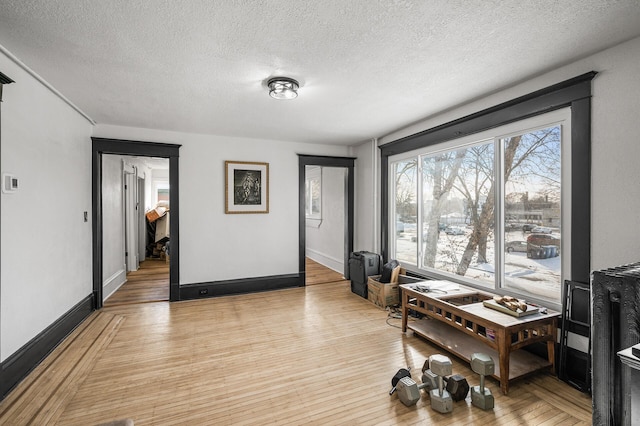 interior space with a textured ceiling and light hardwood / wood-style floors