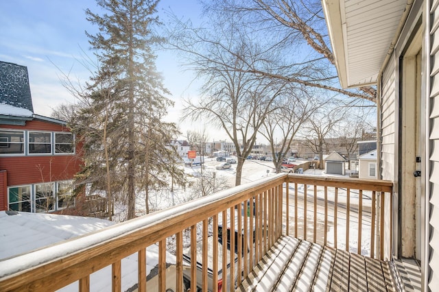 view of snow covered back of property