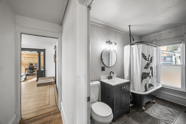 full bathroom featuring vanity, toilet, a textured ceiling, and shower / bath combo