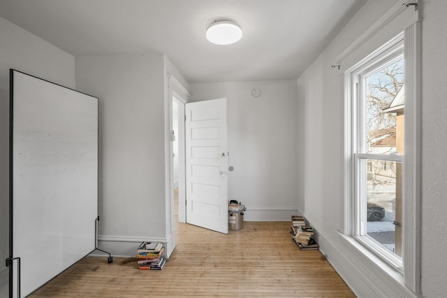 clothes washing area with light hardwood / wood-style floors