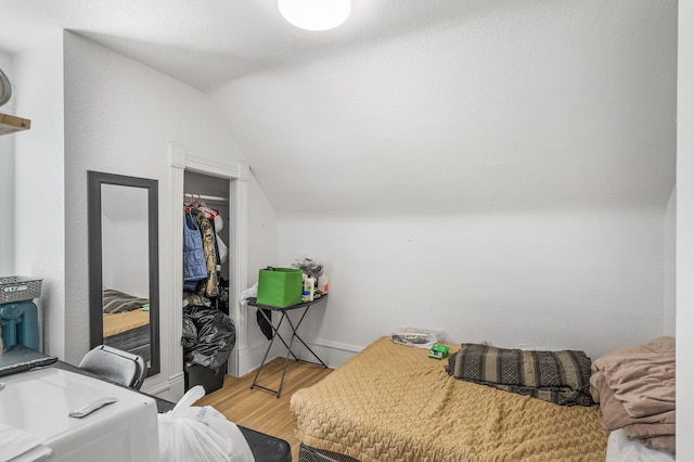 bedroom featuring lofted ceiling and wood-type flooring