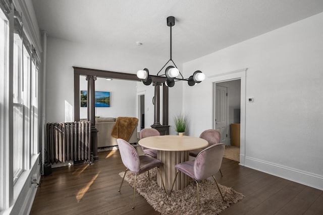 dining area with dark hardwood / wood-style floors and a chandelier