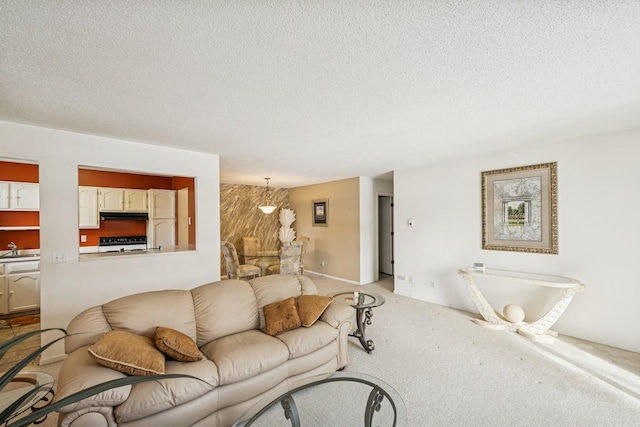 living area featuring light carpet and a textured ceiling