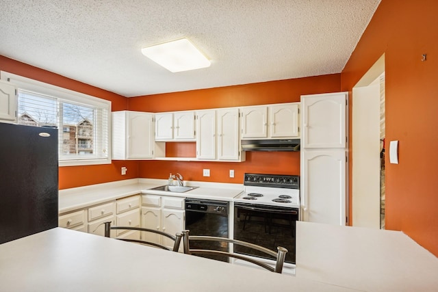 kitchen with under cabinet range hood, a textured ceiling, black appliances, white cabinetry, and a sink