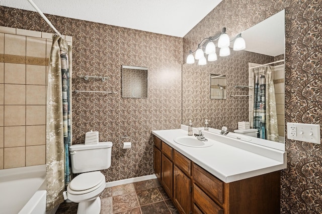 bathroom featuring toilet, wallpapered walls, and vanity