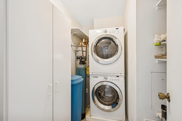 laundry room featuring laundry area and stacked washer / drying machine