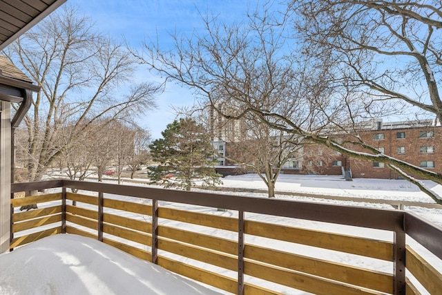 snow covered patio with a balcony