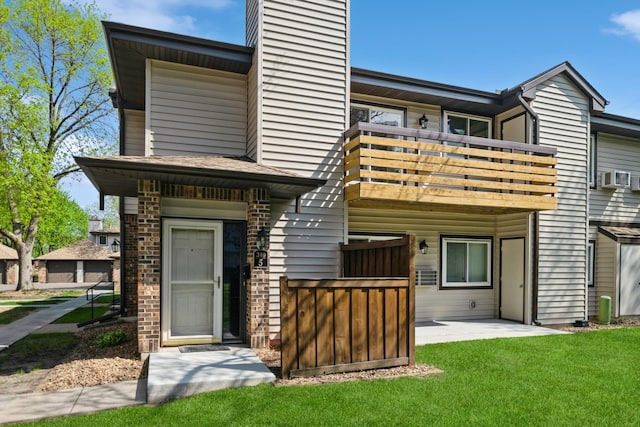 340 Ford Rd Unit 5, Saint Louis Park, MN 55426 - rear view of property with a balcony, a chimney, a yard, a patio, and cooling unit
